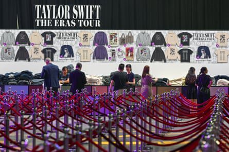 Workers in Singapore prepare the merch stand for Taylor Swift’s Eras tour earlier this year – the tour is set to break a billion dollars in revenue.