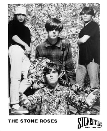 The band members pose for the camera, looking moody.