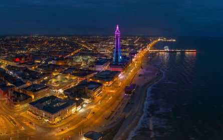 A nighttime aerial view of Blackpool Tower, promenade and Central Pier, Blackpool.